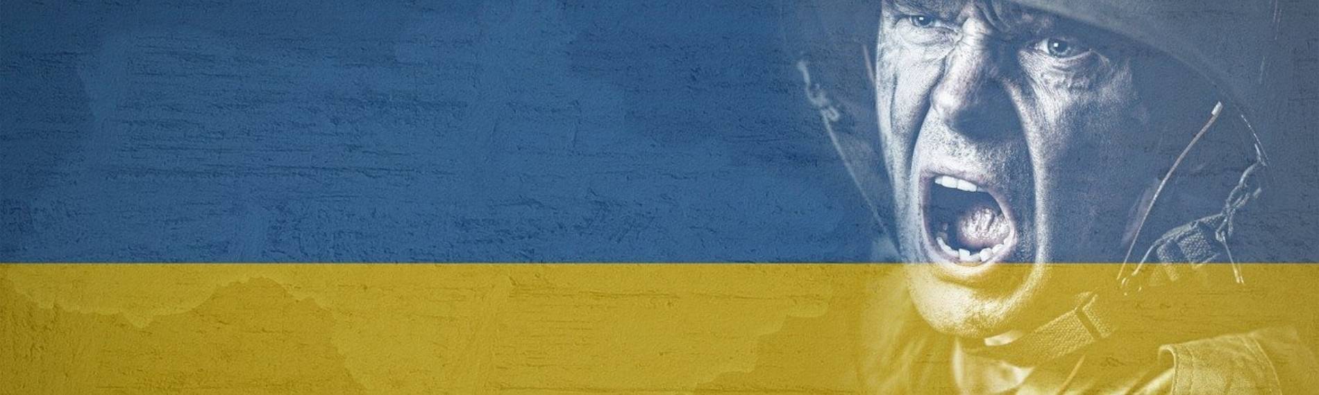 Ukrainischer Soldat verzweifelt vor ukrainischer Flagge